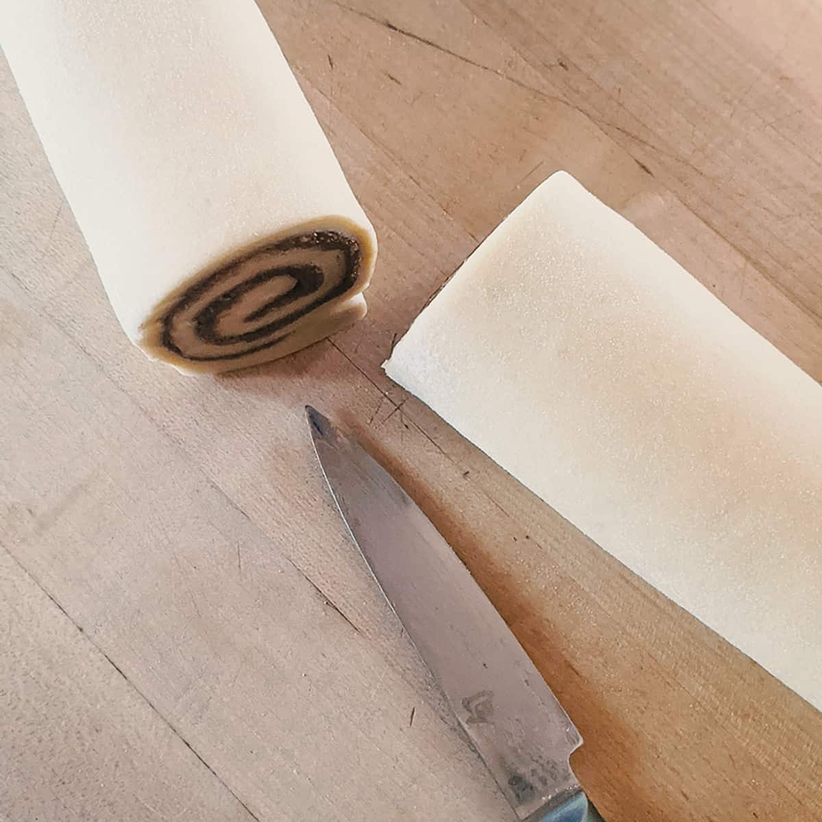 Simple Cinnamon Rolls - cutting the rolled dough
