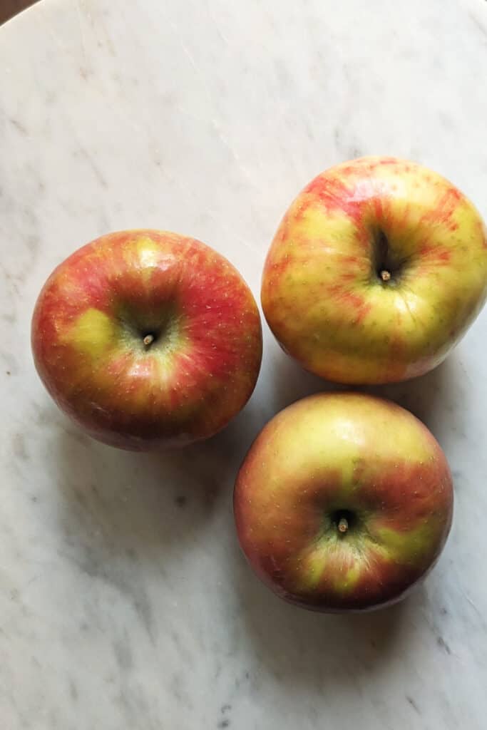 Easy Apple Crisp Crumble - Fresh Apples on a marble slab