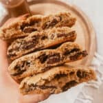 Pinon Chocolate Chip Cookies - hand holding a stack of cookies
